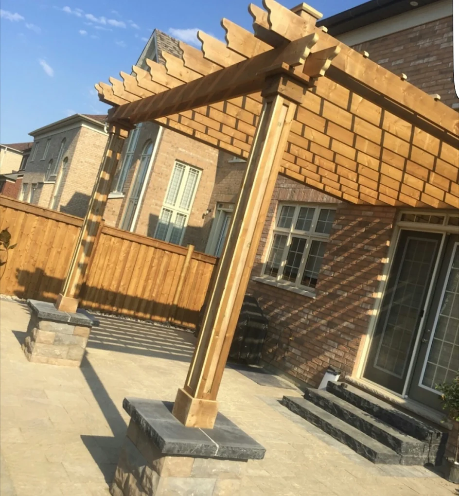 Custom cedar pergola over stone patio